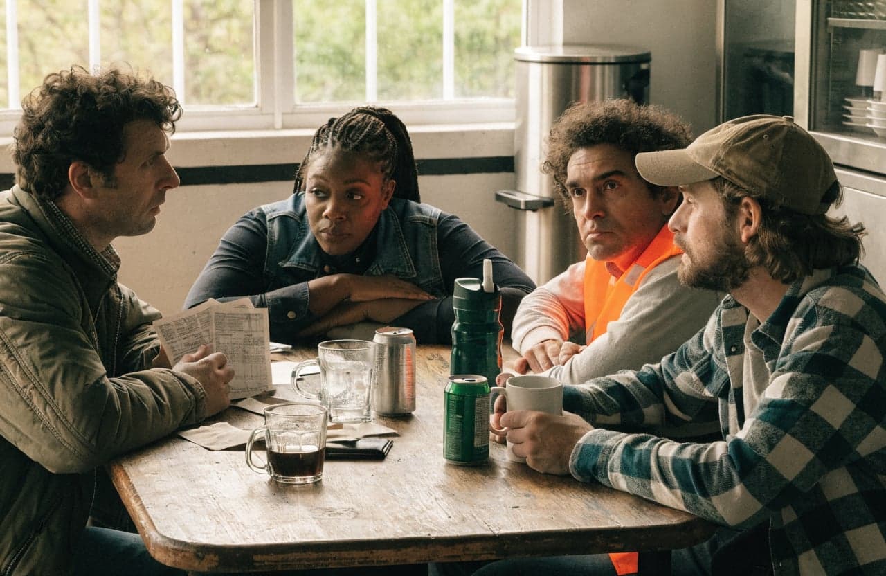 Group of coworkers talking around a break room table after a shift